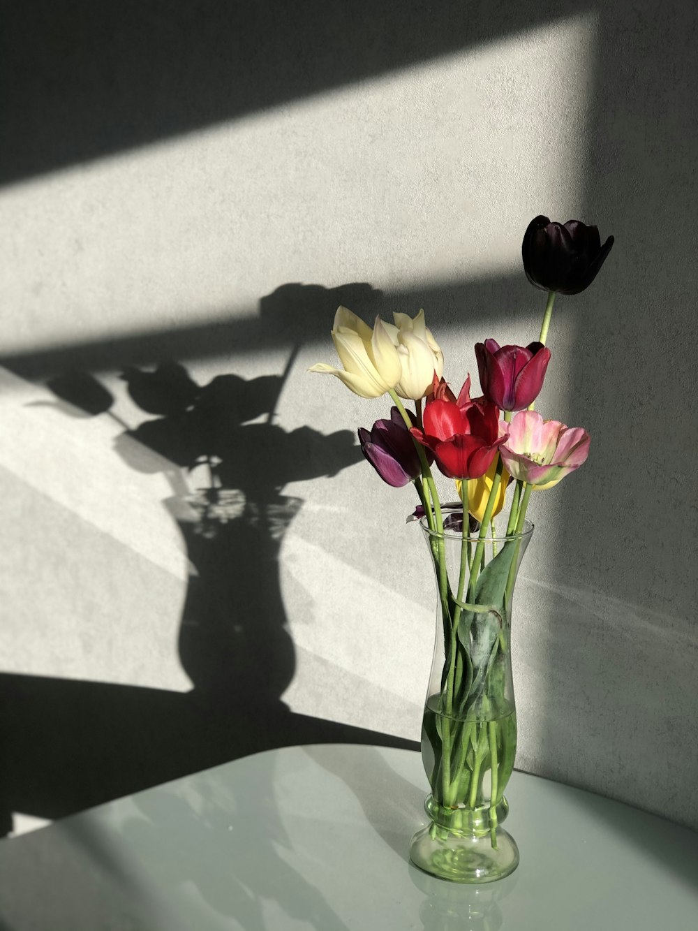 yellow roses in clear glass vase