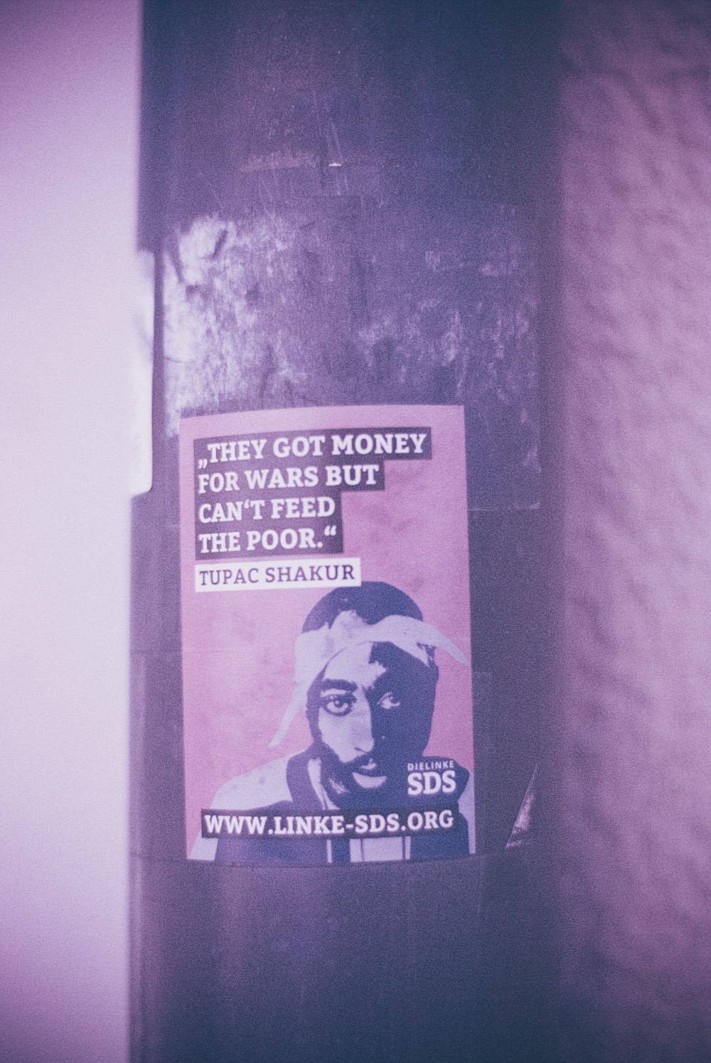 a sticker on a pole with a picture of a man on it