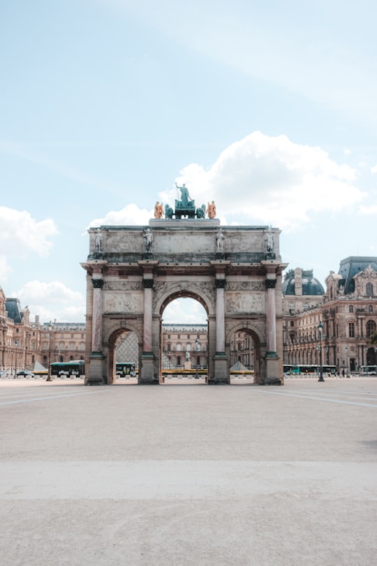 people walking on gray concrete road near beige concrete building during daytime in Arc de Triomphe du Carrousel France