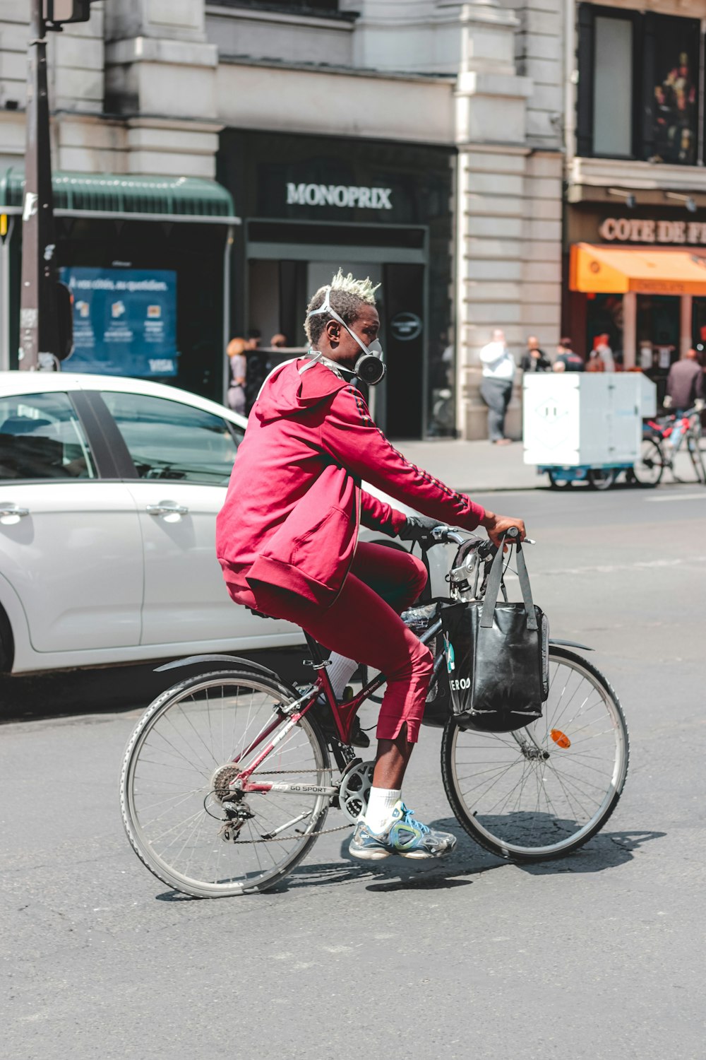 uomo in giacca rossa che va in bicicletta durante il giorno