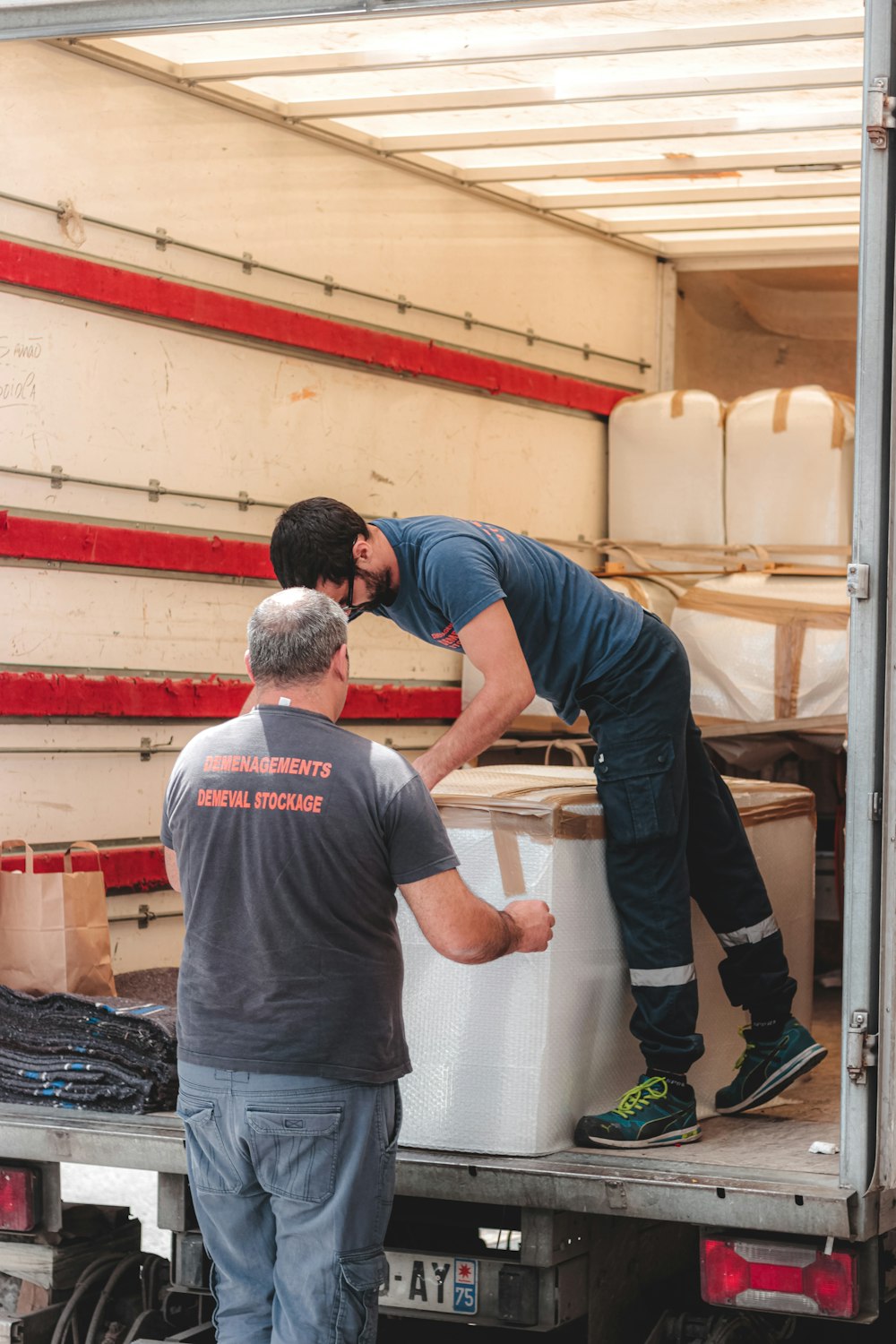 man in gray t-shirt and green pants