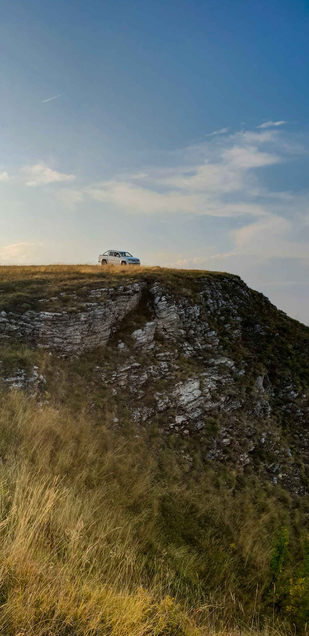 white van on gray rock mountain during daytime