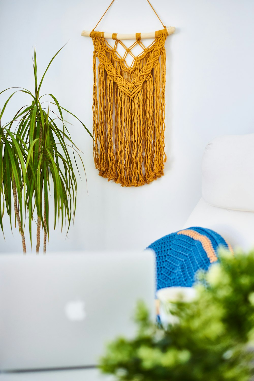 gold colored cross pendant on white couch