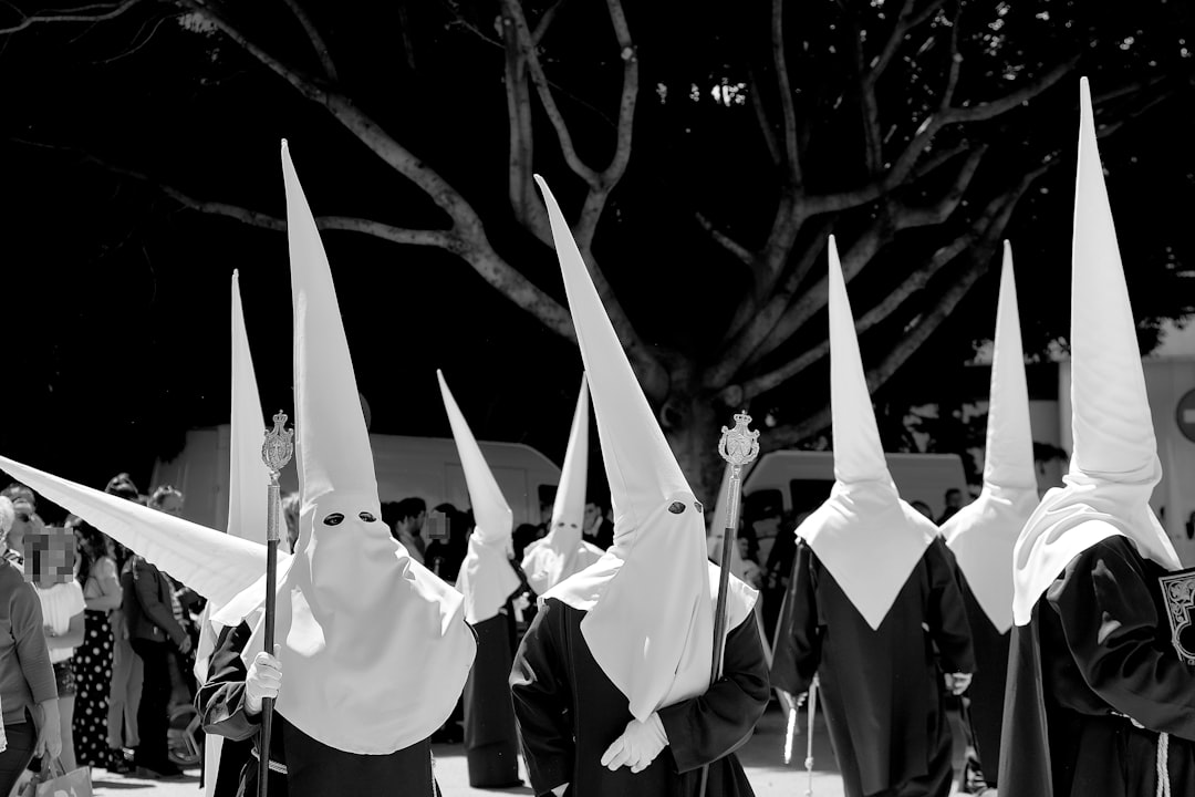 white and black flags on black metal pole