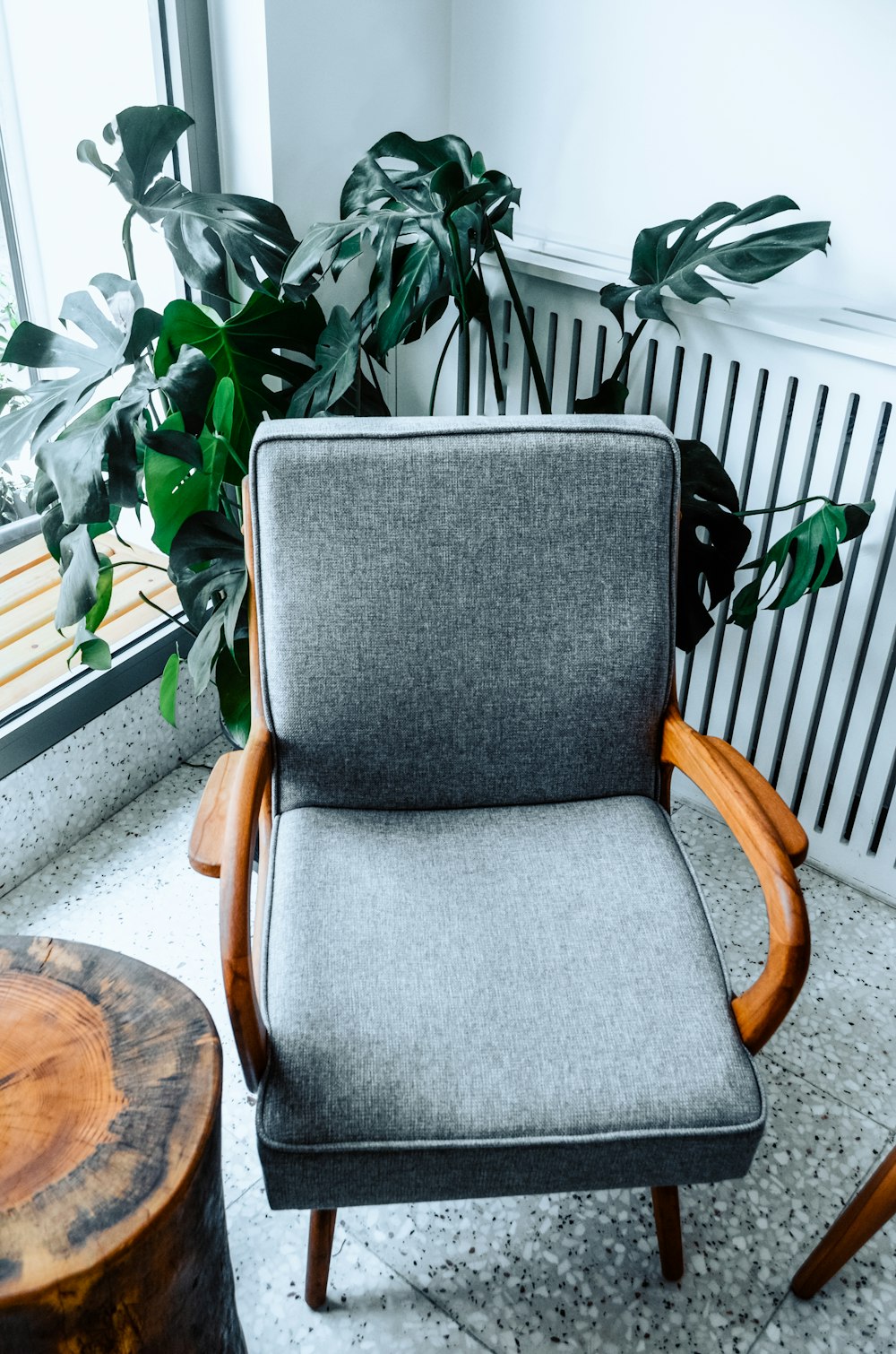 gray padded brown wooden armchair