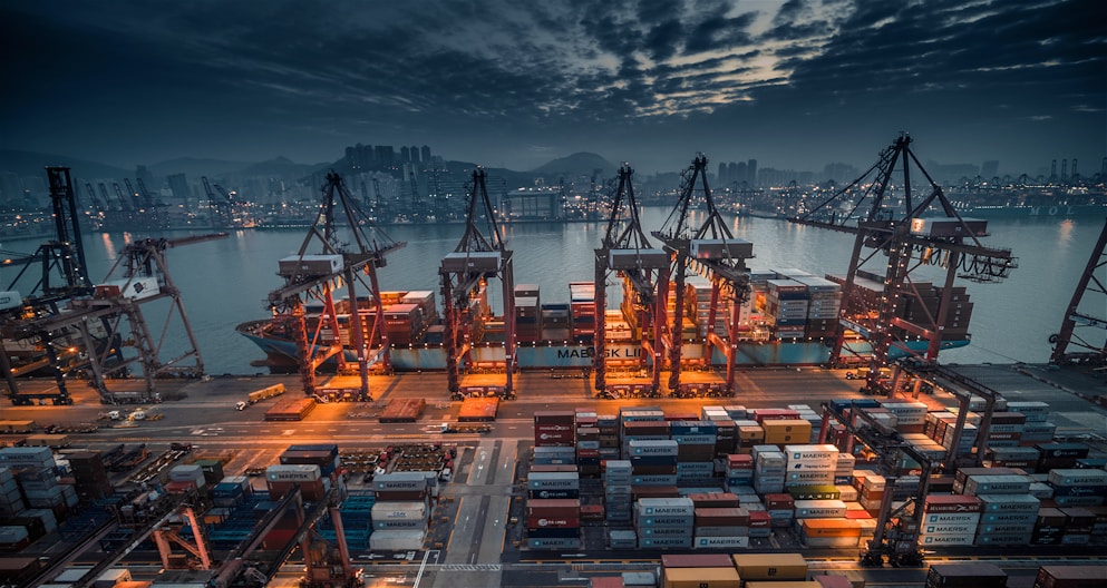 red and black cargo ship on dock during daytime