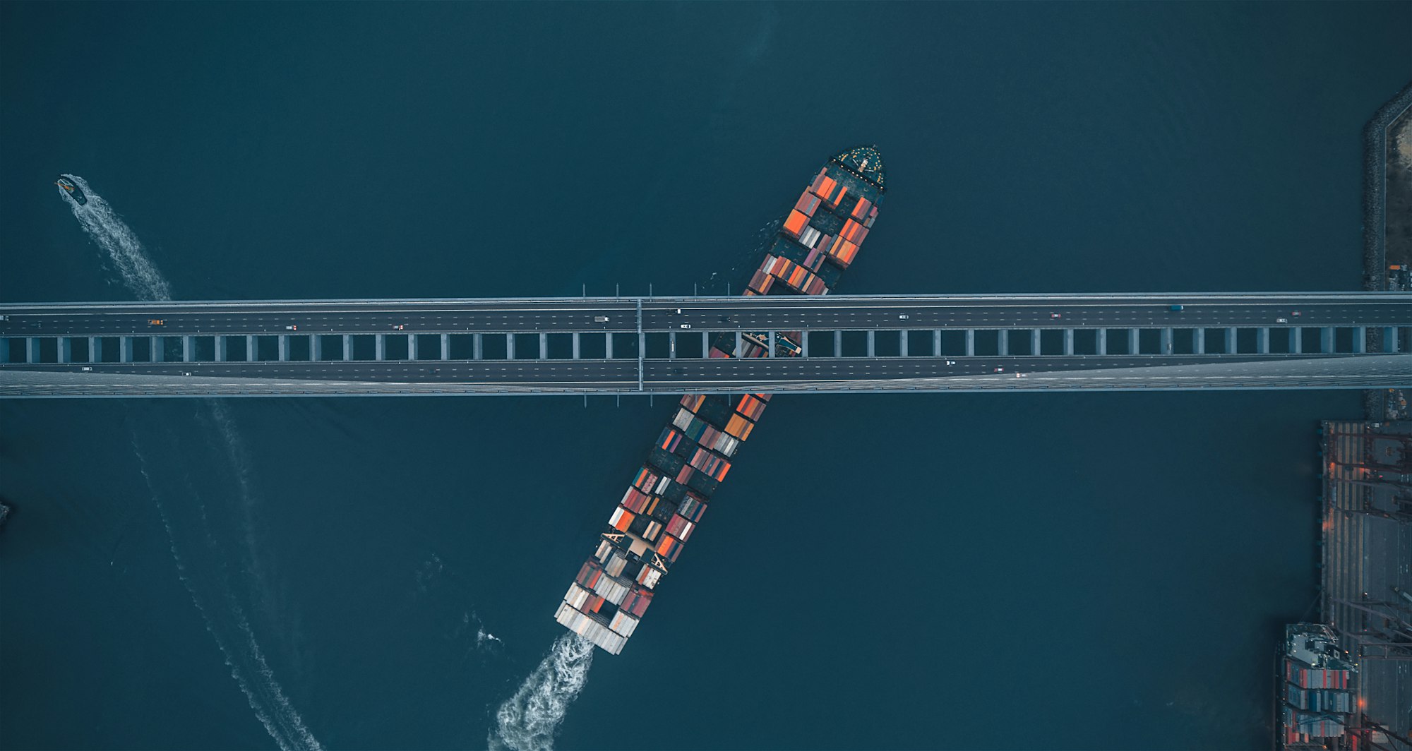 High-angle view of red and white port building / container yard — symbolising global trade & sovereign debt corridors
