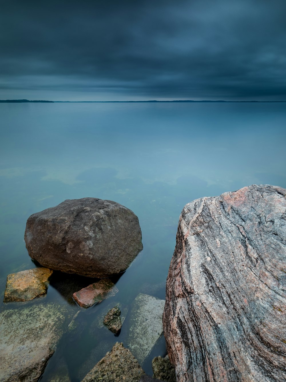 gray rock formation near body of water during daytime