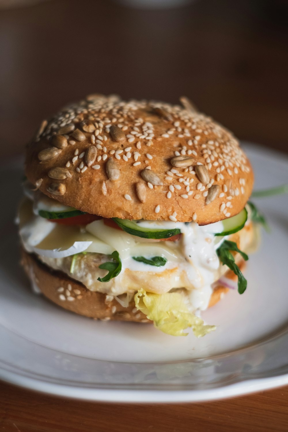 burger with lettuce and cheese on white ceramic plate