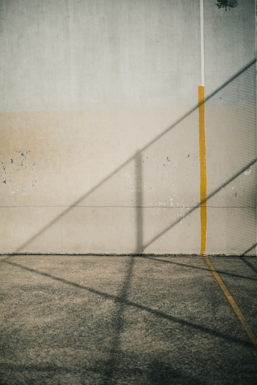 yellow metal pole on gray concrete floor
