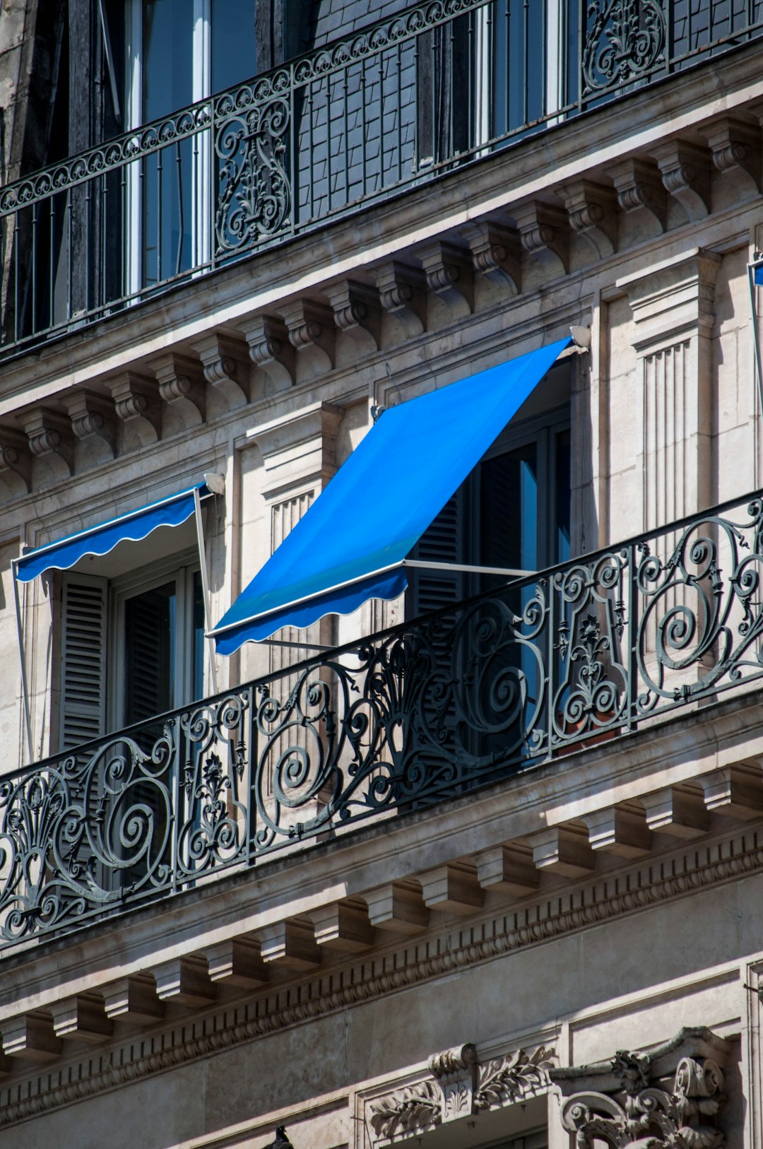 blue umbrella on white concrete balustrade