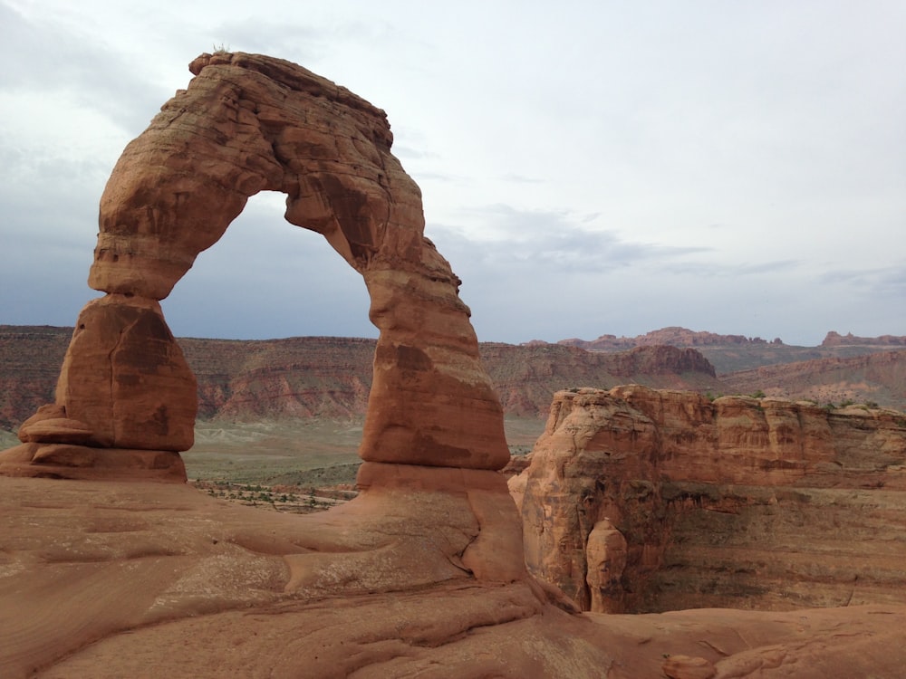 brown rock formation under white clouds during daytime