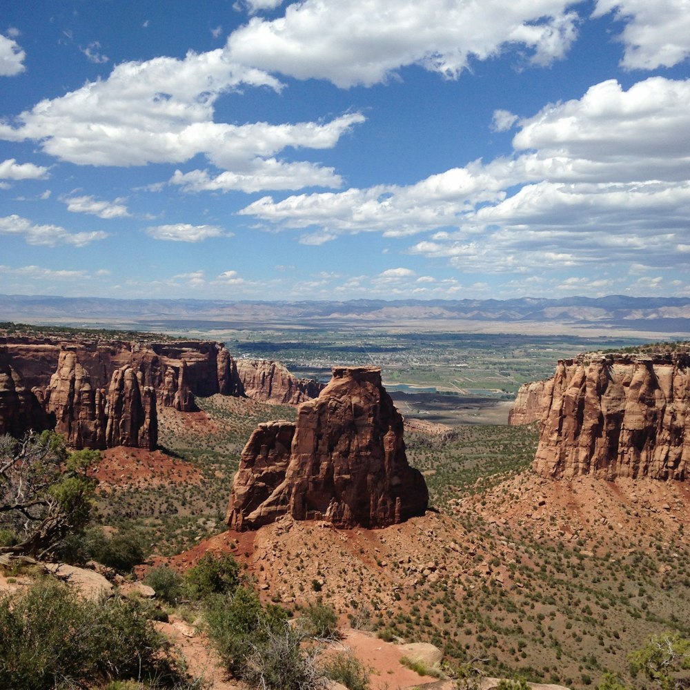 brown rock formation under blue sky and white clouds during daytime