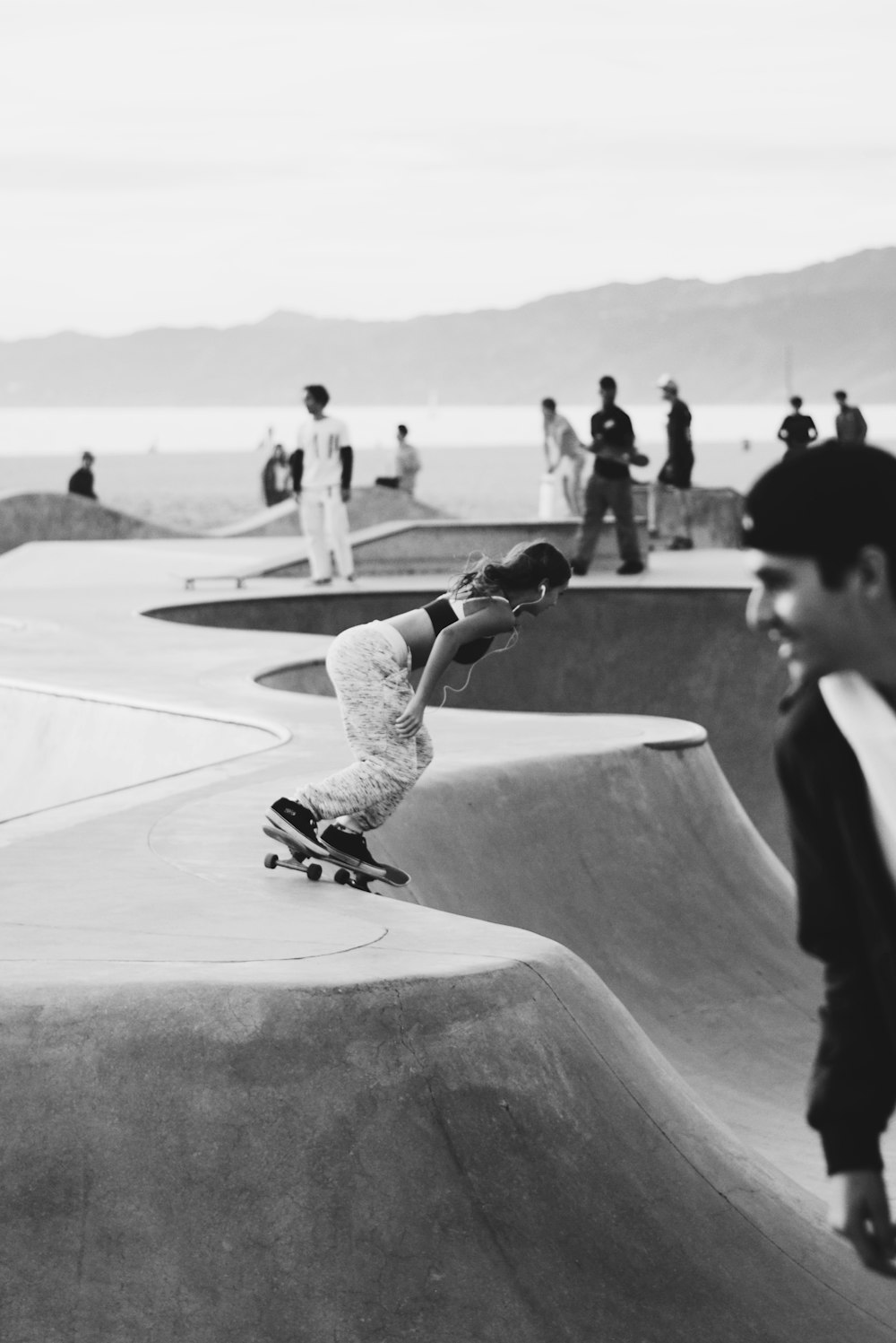 man in black t-shirt and white pants riding skateboard