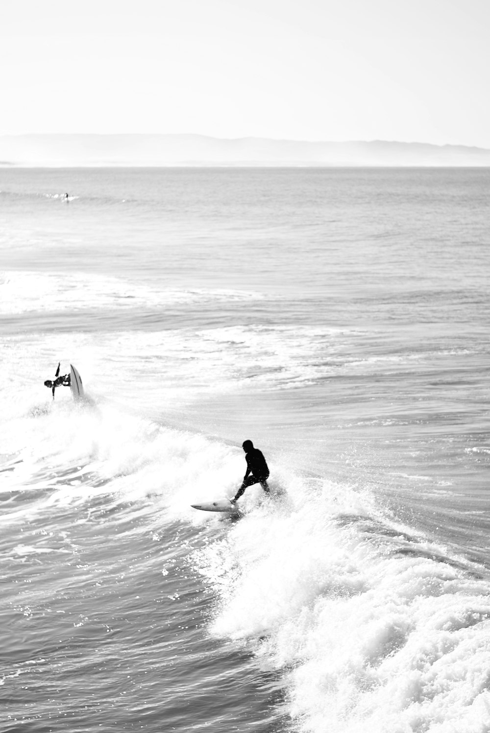 man surfing on sea waves during daytime