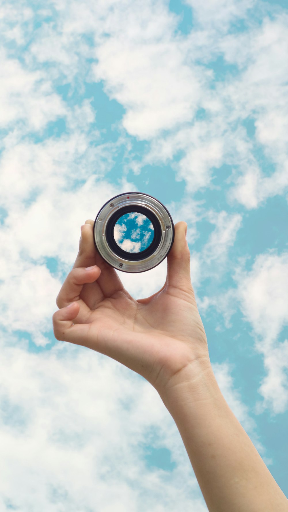 person holding round black and white camera lens