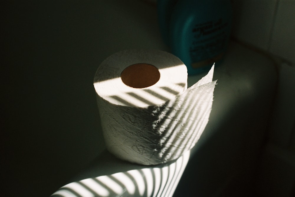 white tissue roll on black table