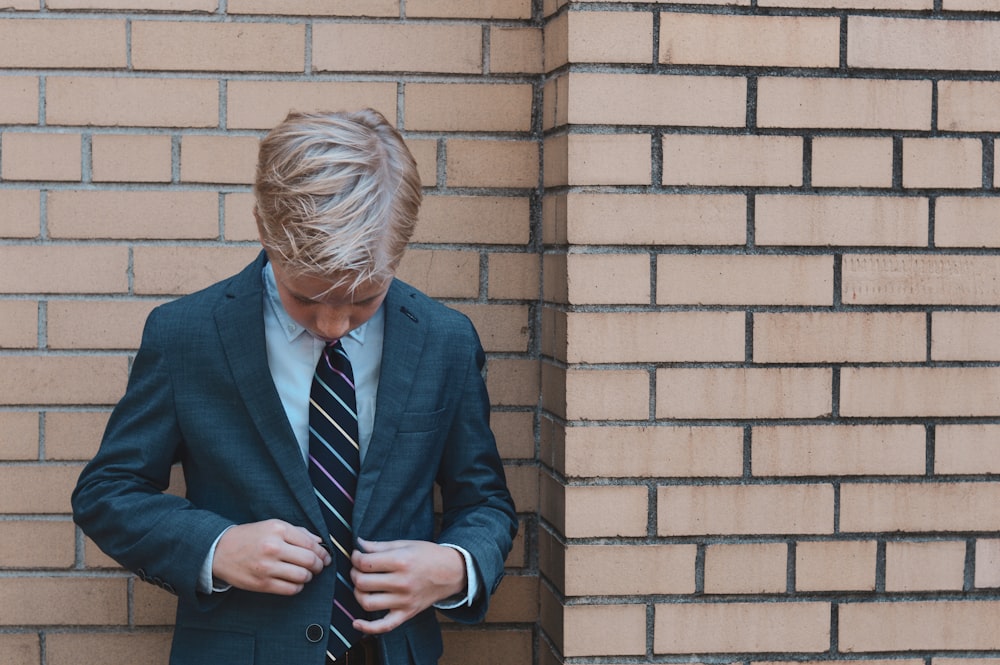 man in blue suit jacket and blue necktie