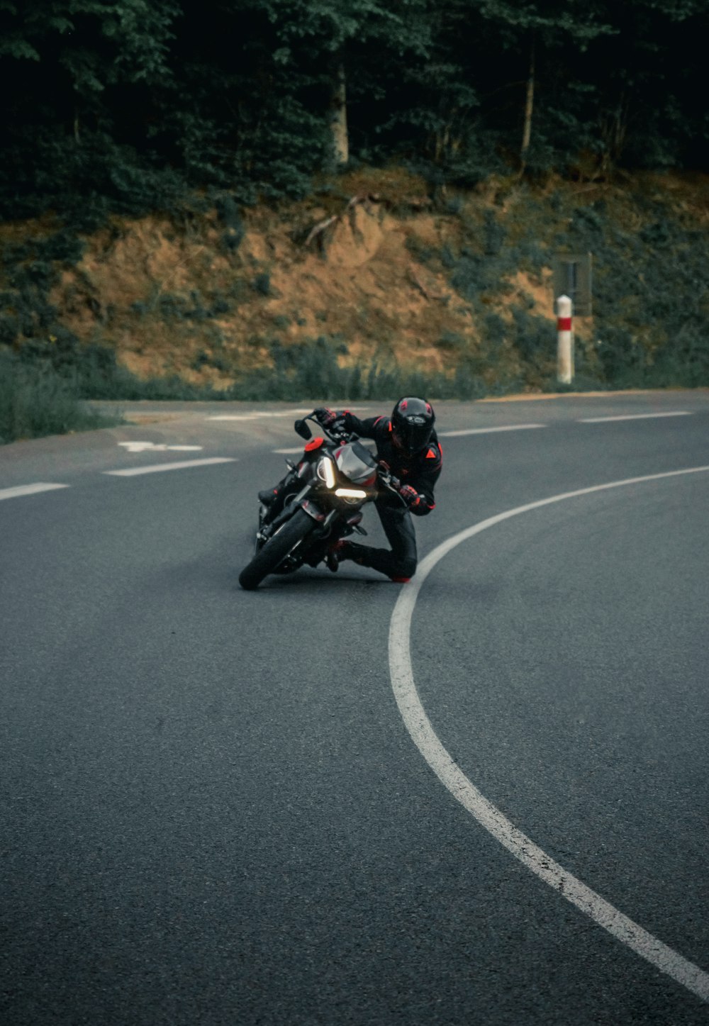 man in black jacket riding motorcycle on road during daytime