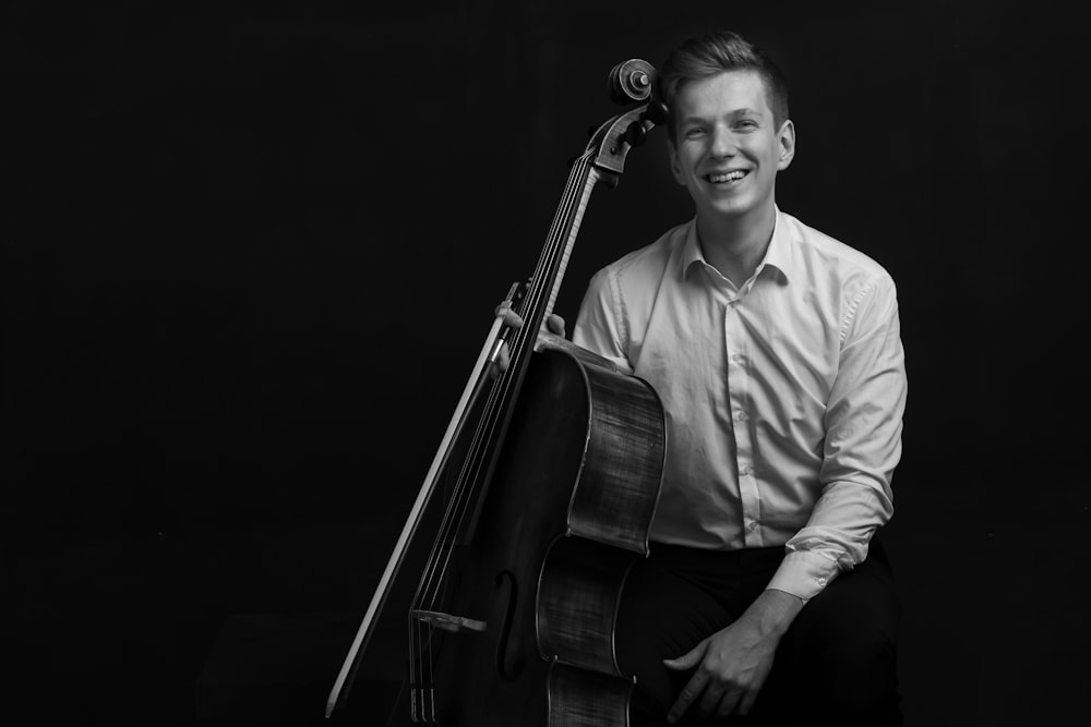 man in dress shirt playing violin