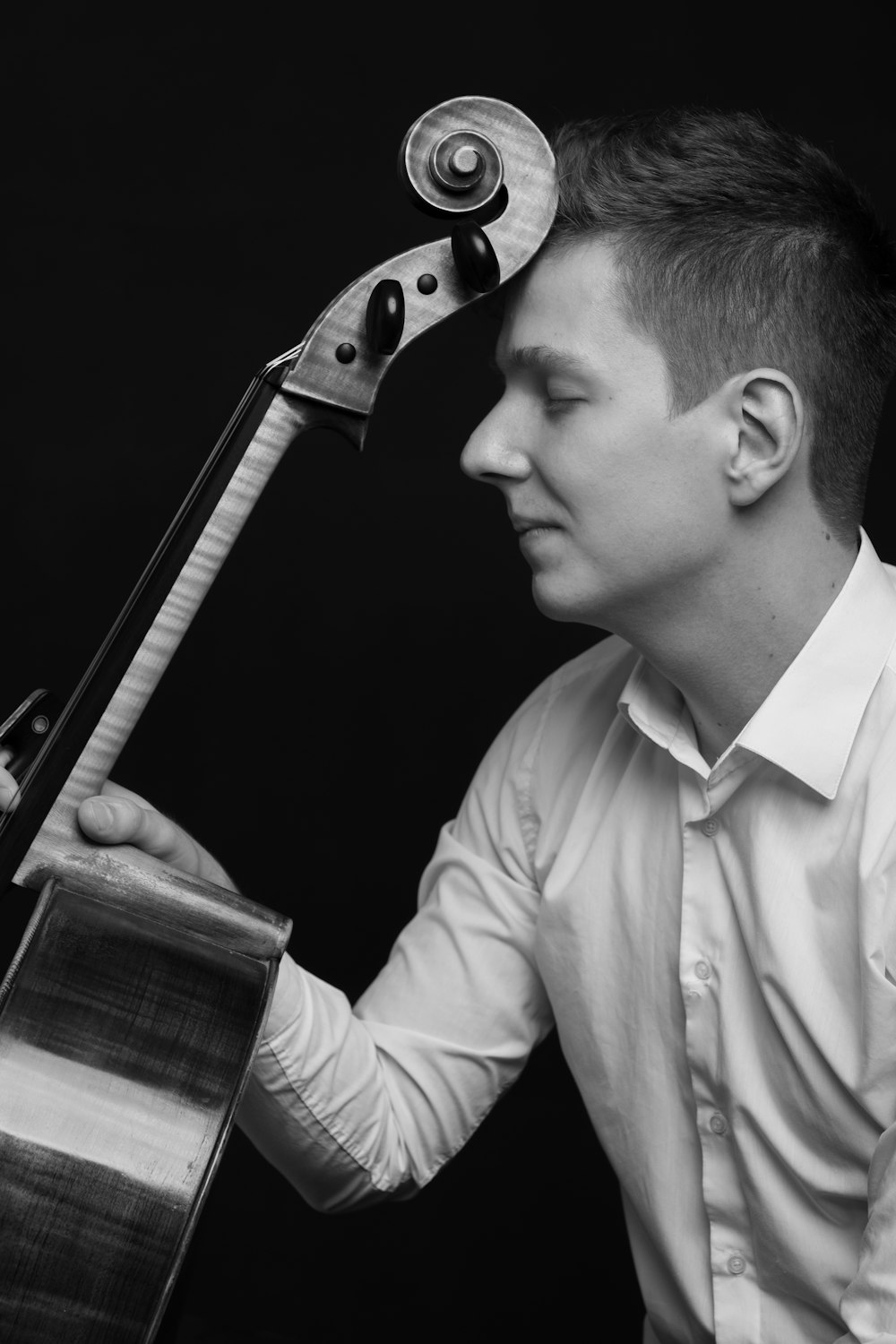 man in white dress shirt playing guitar