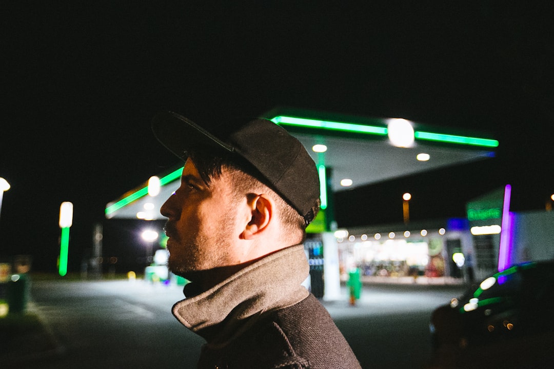 man in black jacket wearing black cap