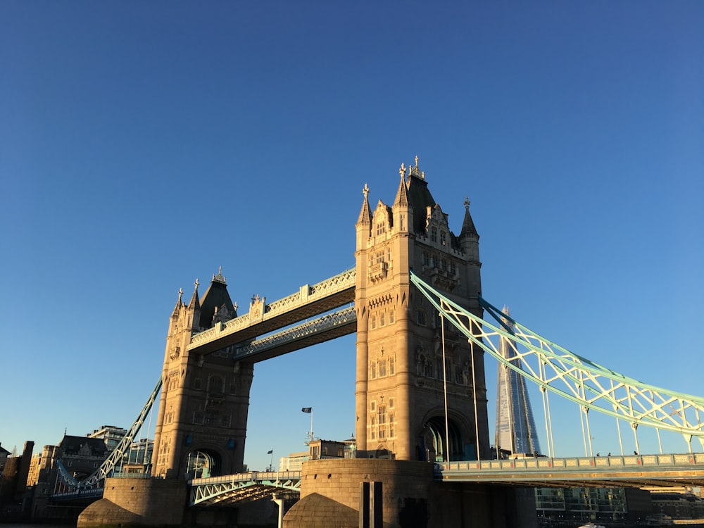 brown concrete bridge under blue sky during daytime