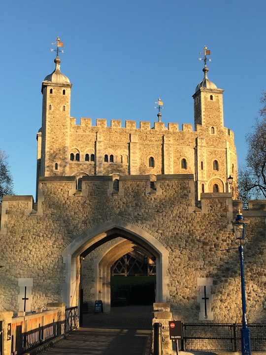 brown brick building under blue sky during daytime in Tower of London United Kingdom