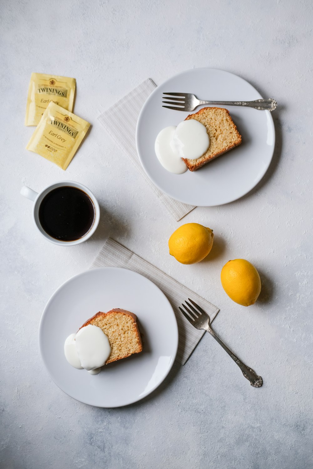 sliced bread on white ceramic plate beside stainless steel fork and knife