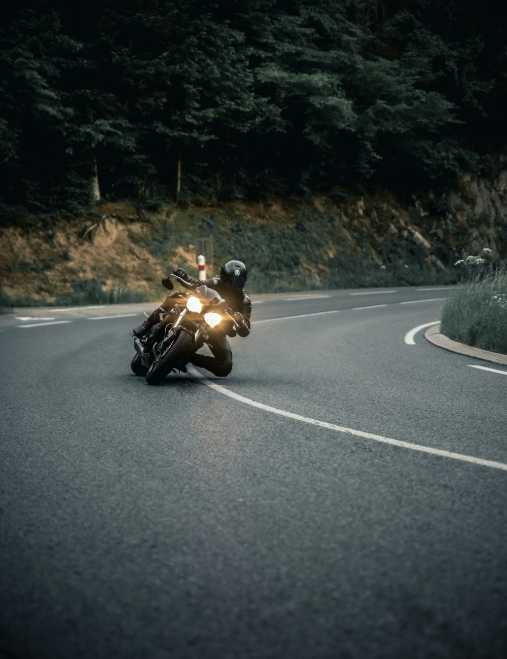 man riding motorcycle on road during daytime