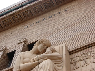 woman in dress concrete statue