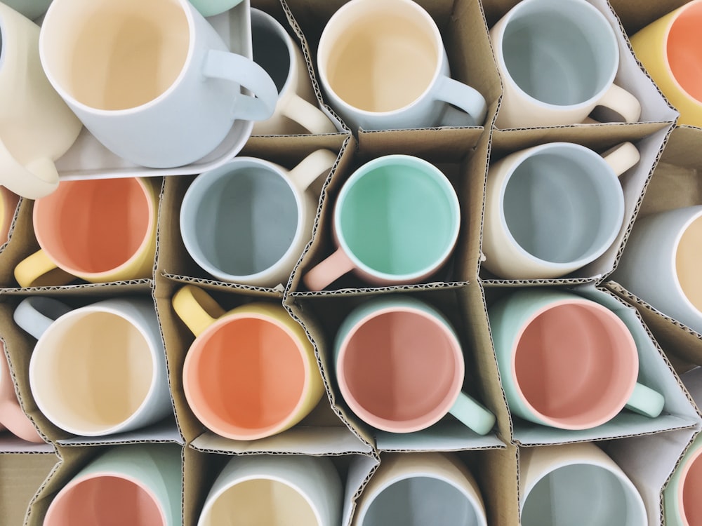 white blue orange and green ceramic mugs