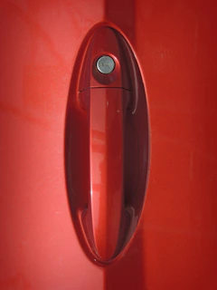 Close-up of a Mercedes car door lock being skillfully picked by a professional locksmith.