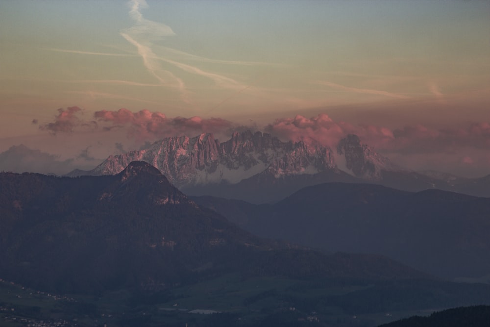 brown and white mountains under white clouds during daytime