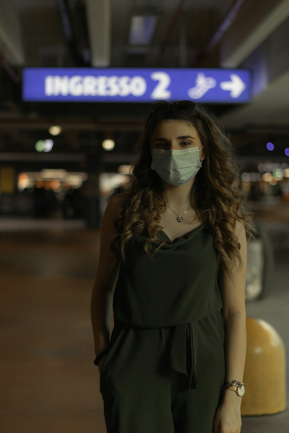 woman in black sleeveless dress wearing white goggles