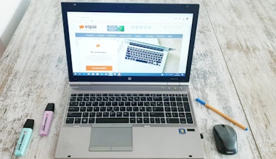 An open laptop displaying university application forms and scholarship information.