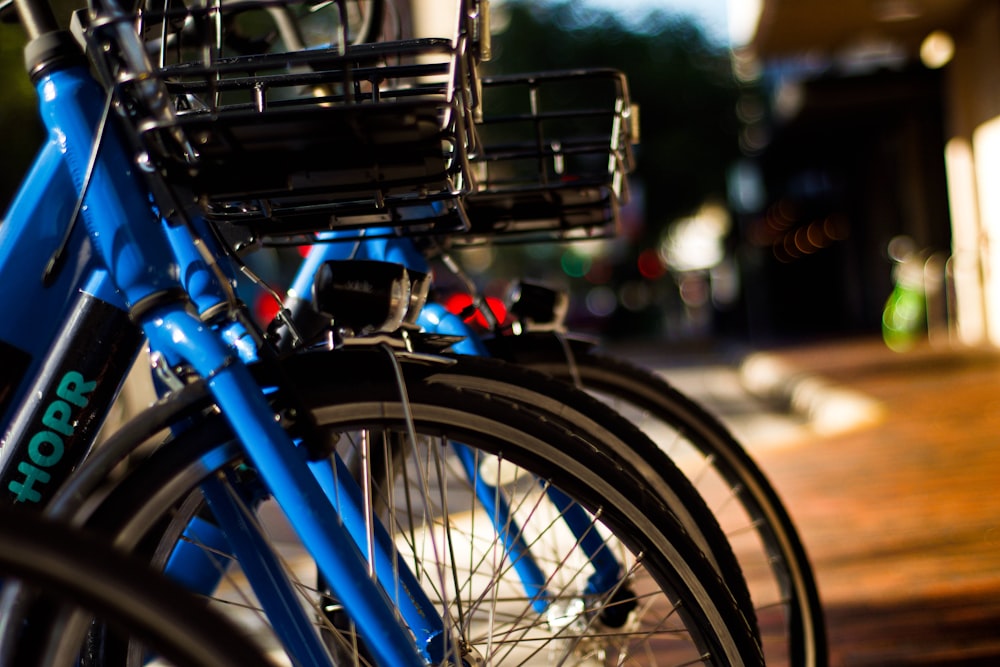 blue bicycle with basket on bicycle rack