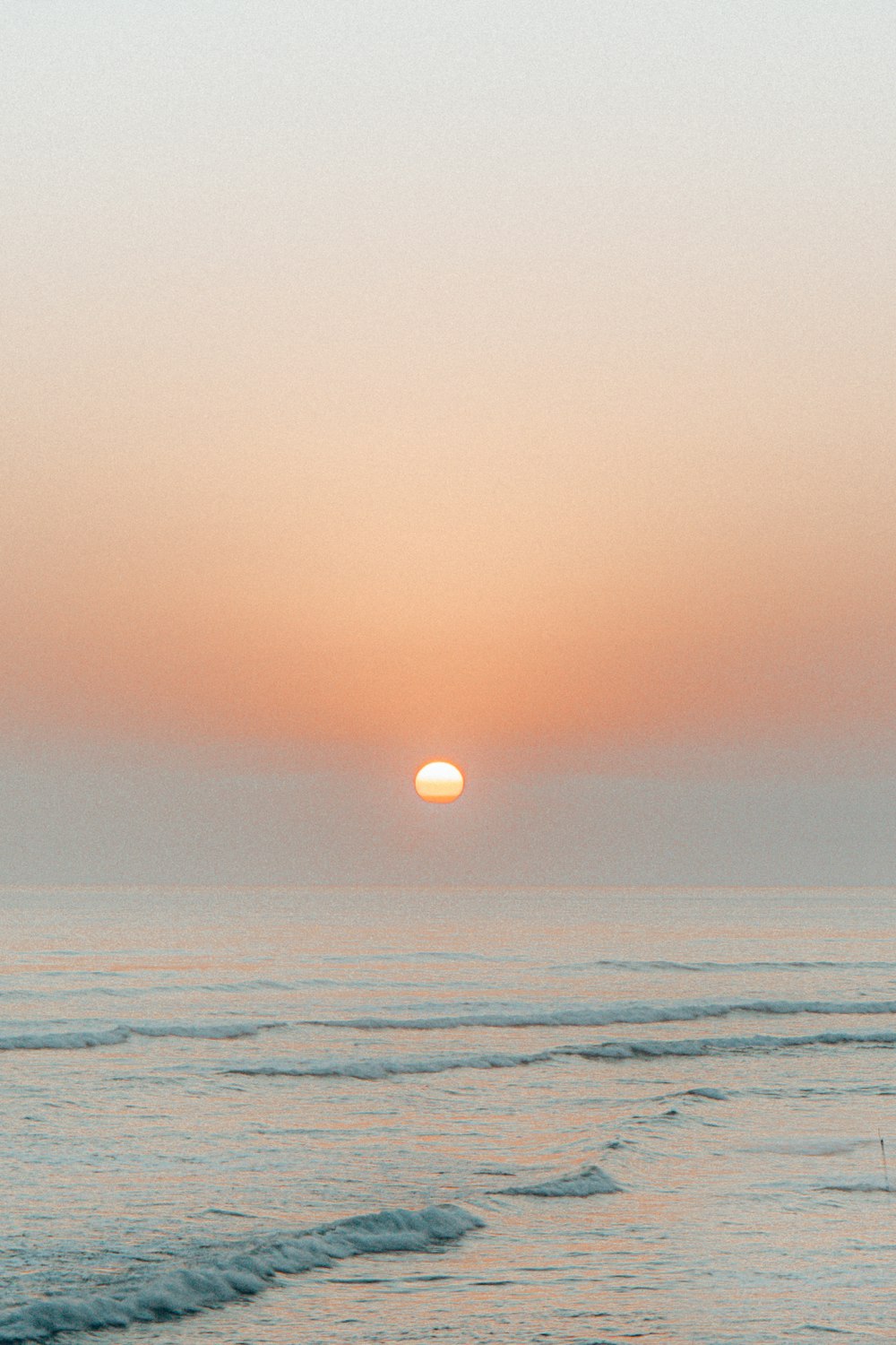 body of water during sunset