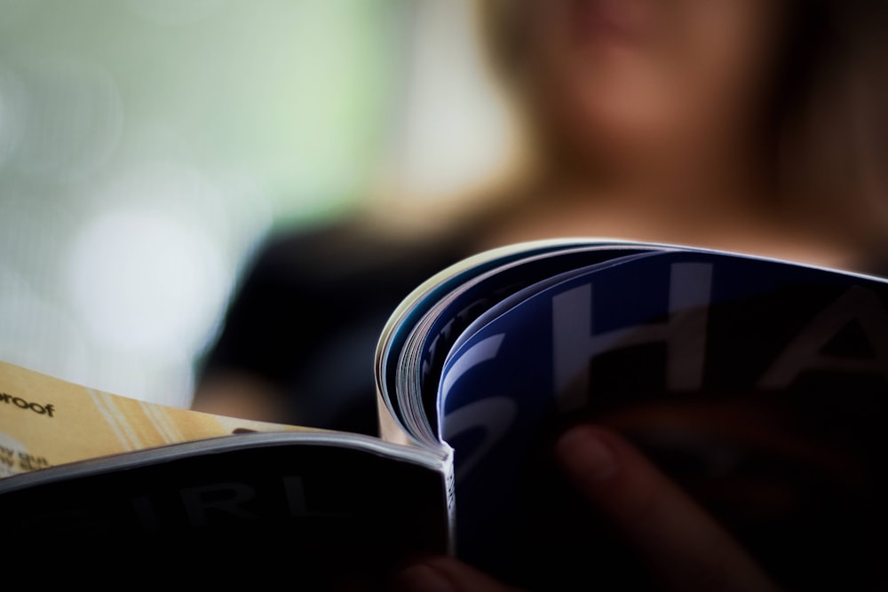 blue and silver can on persons hand