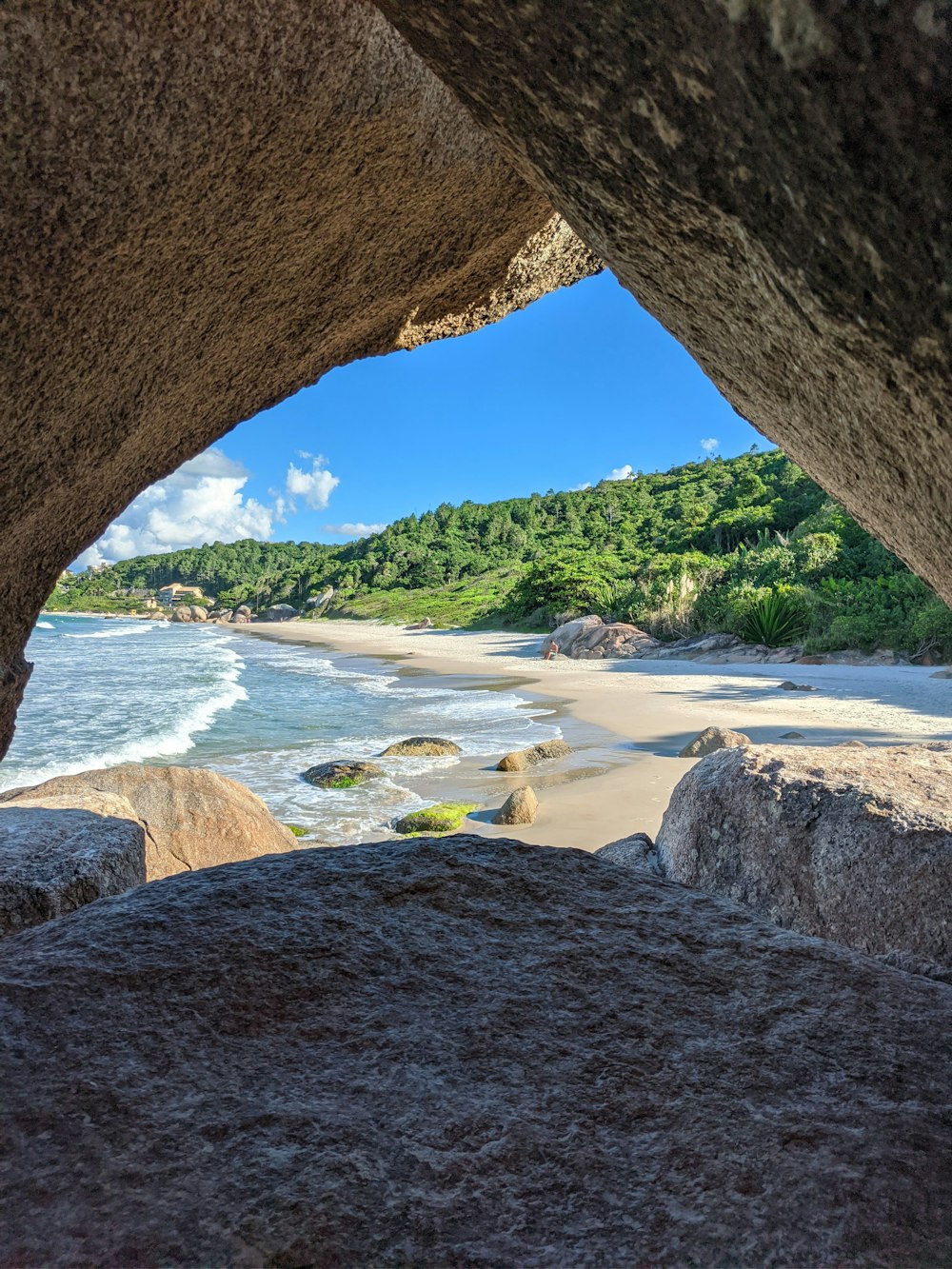 brown rock formation near body of water during daytime