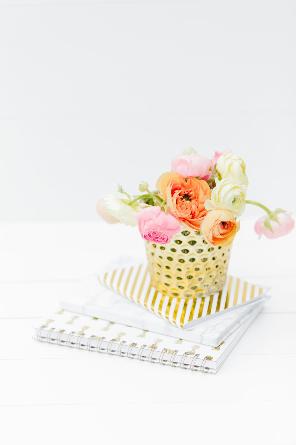 pink and white roses on white and black polka dot ceramic vase