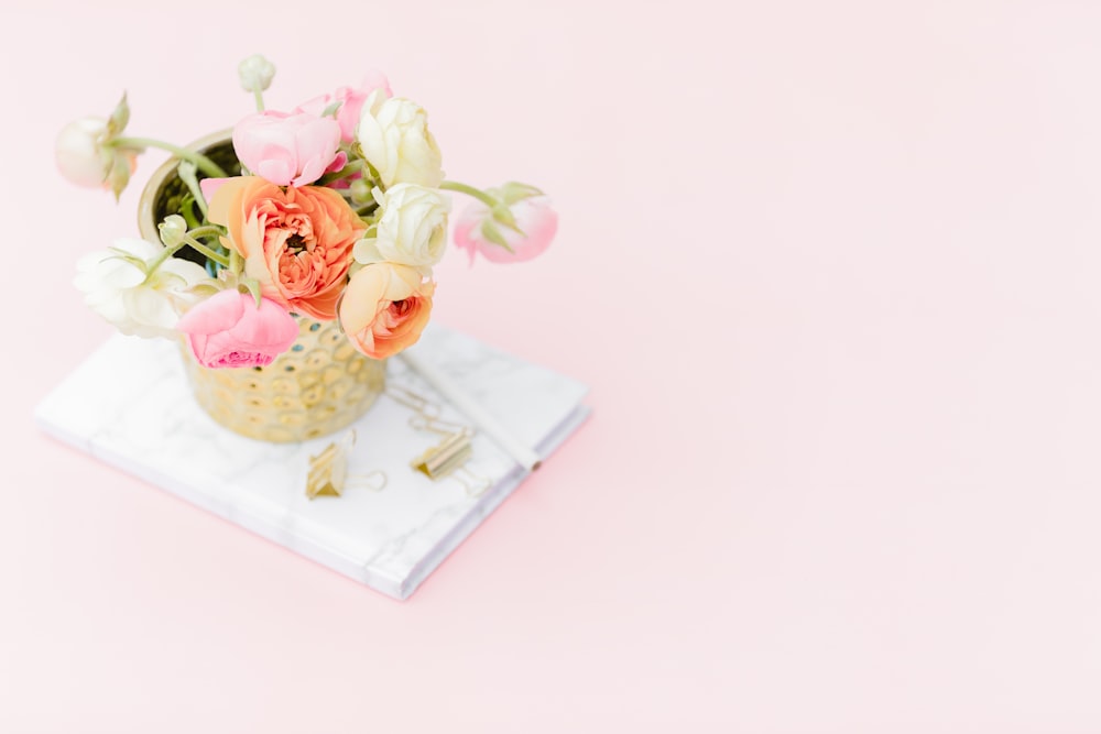 pink roses on white ceramic vase