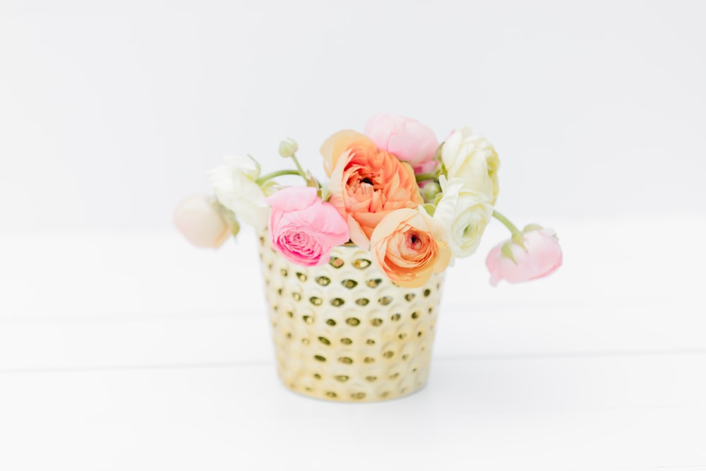 pink roses in gray and white polka dot ceramic vase