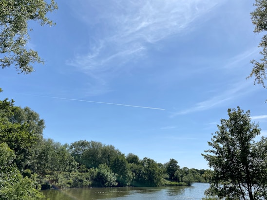 A vibrant collage showing an airplane mid-flight, a serene river with a small boat, and a scenic highway stretching into the horizon.