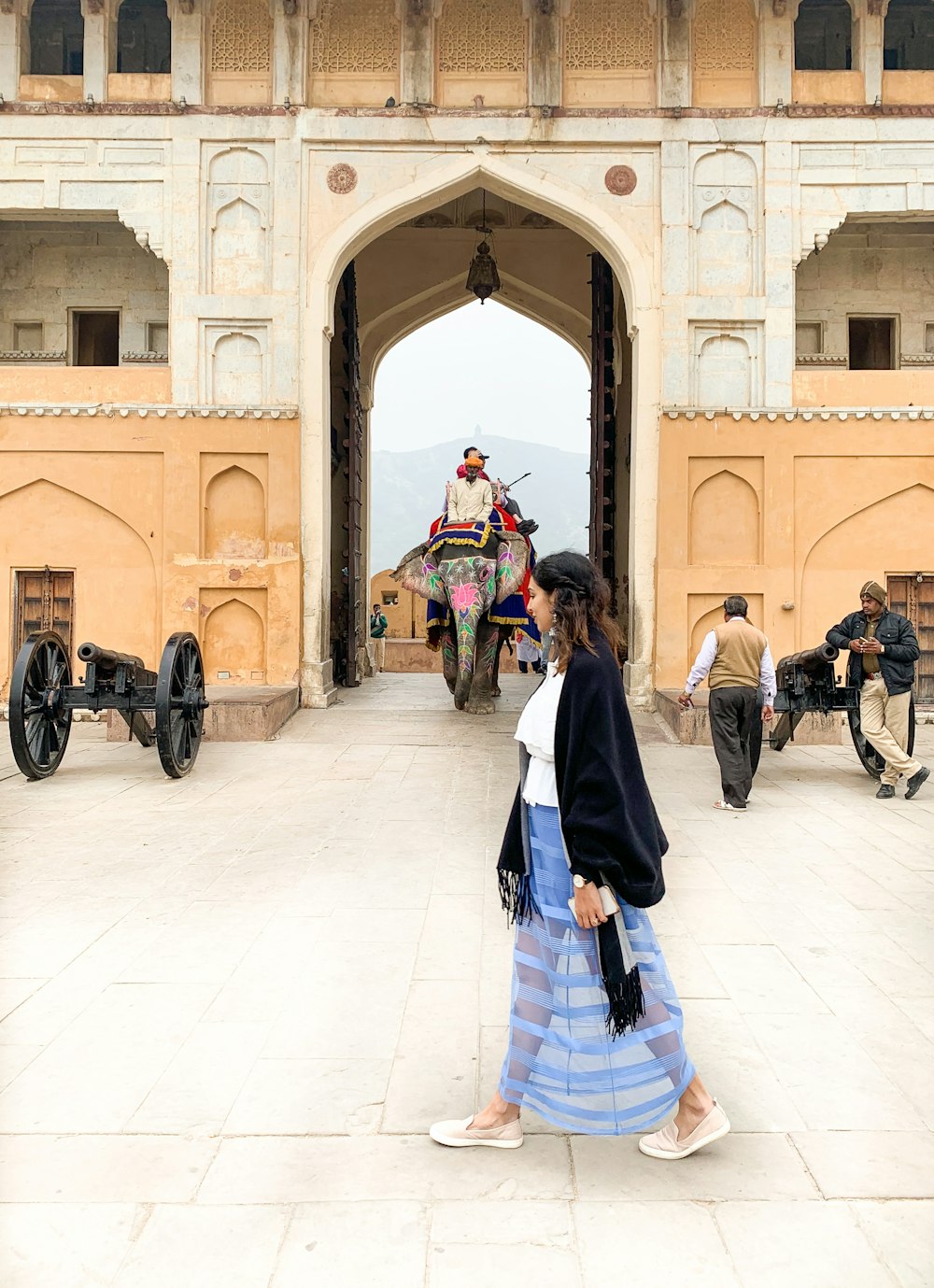 people walking on white floor tiles during daytime