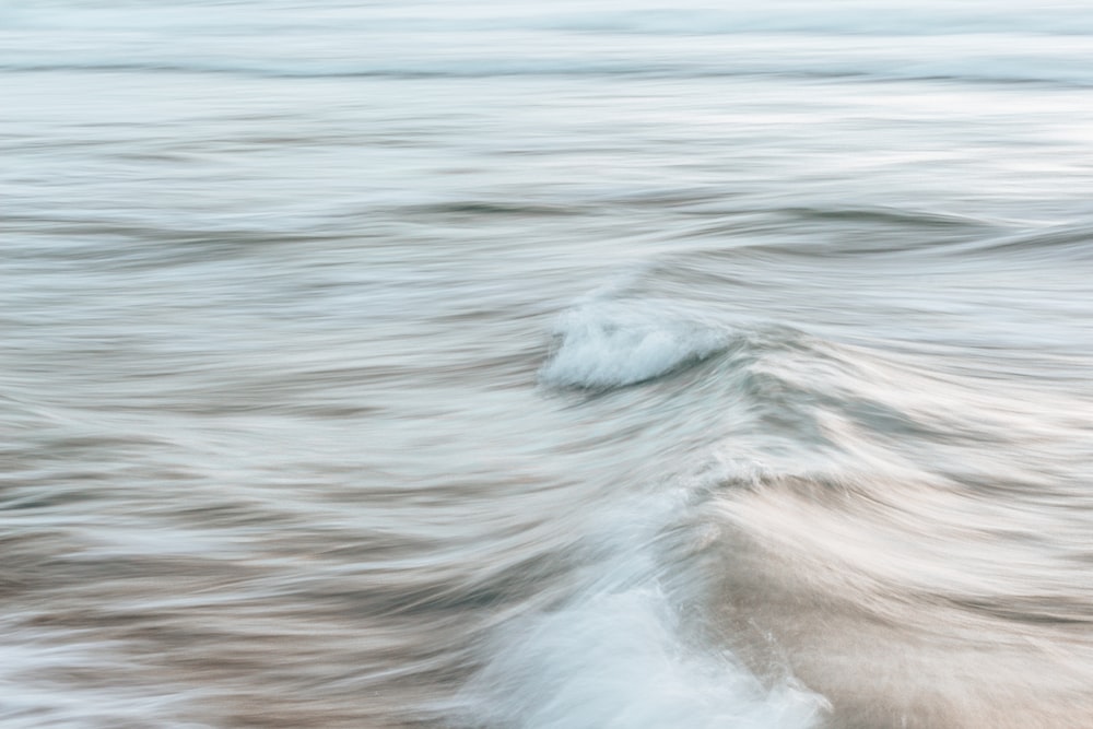 water waves hitting brown sand