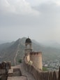 brown concrete building on top of mountain during daytime