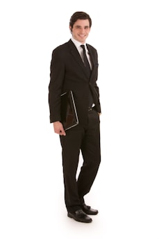 A smiling job seeker holding a printed resume with a confident posture.