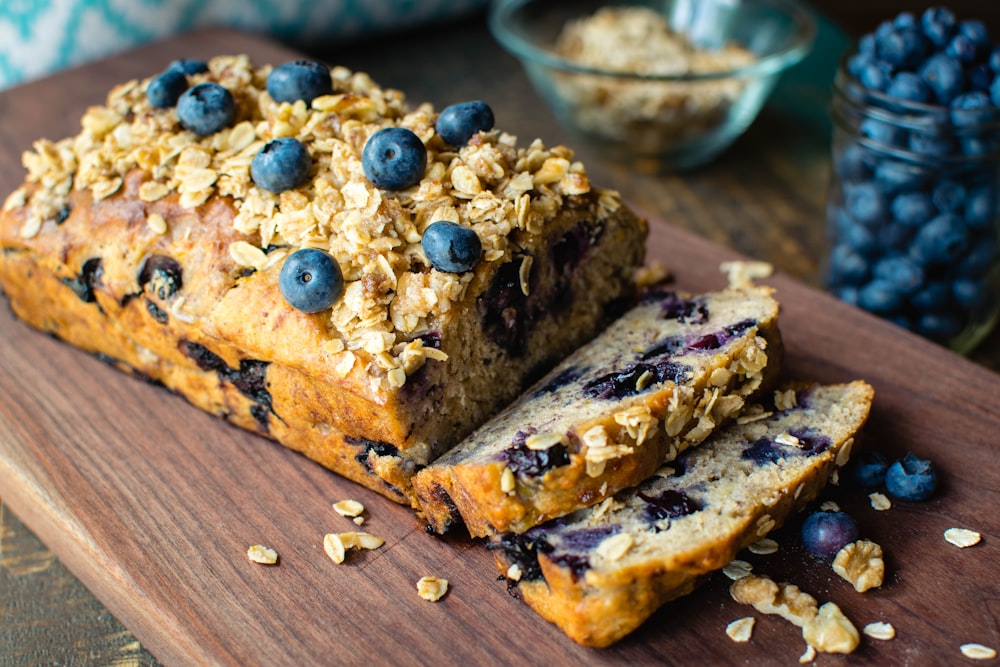 sliced bread with blue berries on brown wooden table