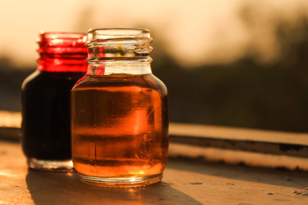 clear glass jar with brown liquid